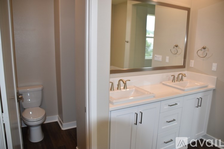 A bathroom with a toilet and a sink.