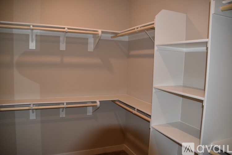 Empty shelves in a room with beige walls.