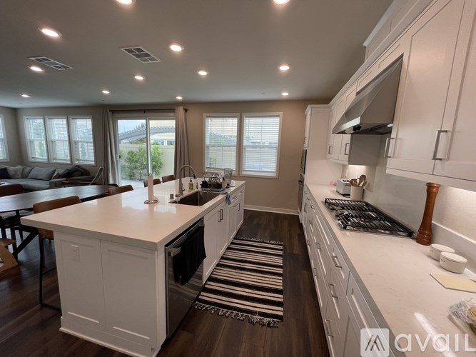 A modern kitchen with white cabinets and a large island.