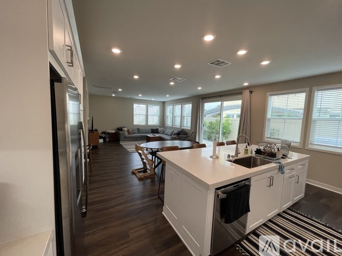 A modern kitchen with white cabinets and a large island.