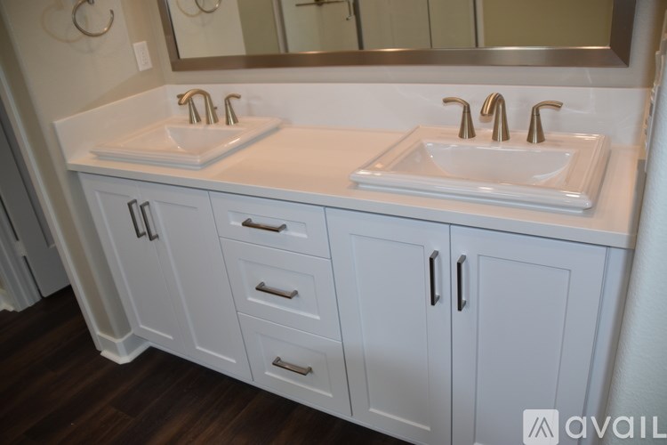 A bathroom with two sinks and a mirror.