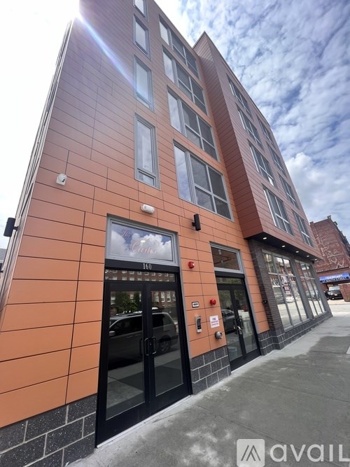 A building with a red and black exterior and a glass door.