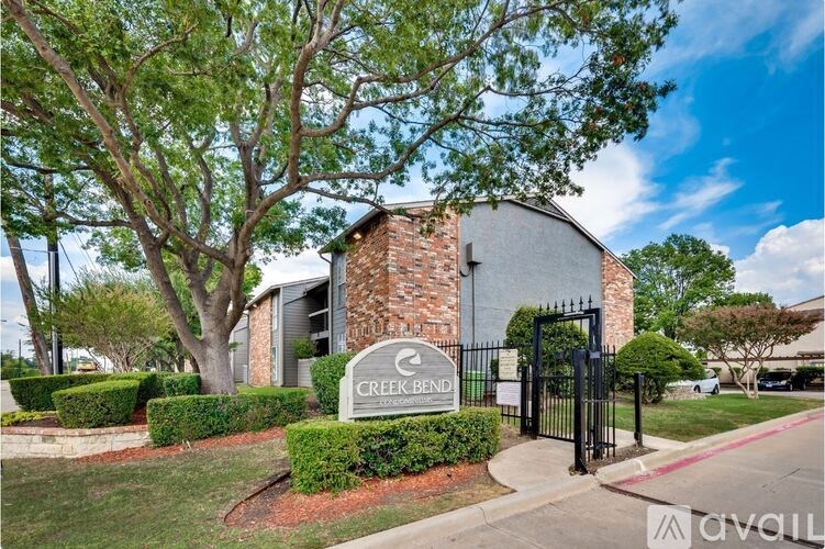 The image shows a building with a sign that reads "CREEKBEND" in front of it.