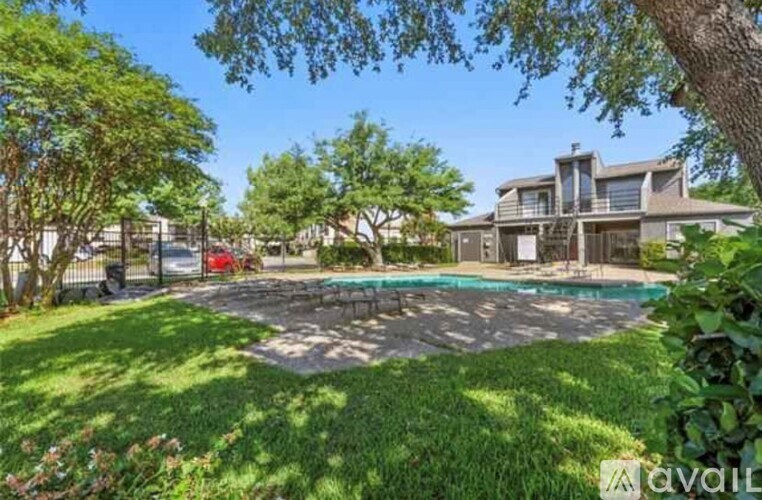 A house with a pool in the backyard surrounded by trees.