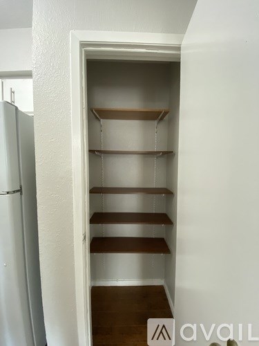 A white doorway with a shelving unit inside.