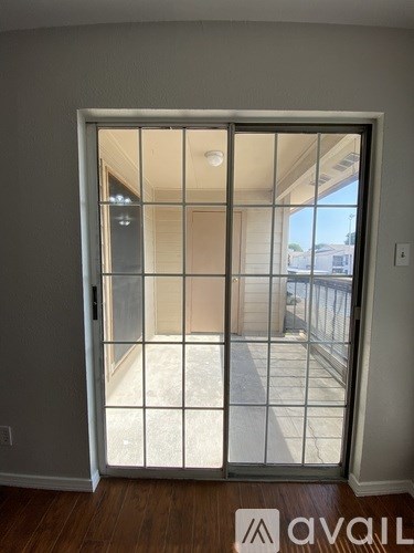 A room with a sliding glass door leading to a balcony.