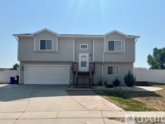 A two-story house with a garage and a driveway.
