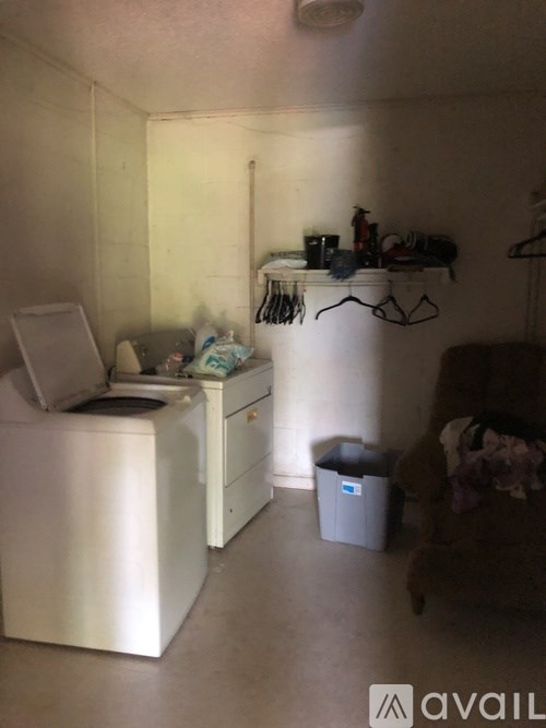 A small laundry room with a washer and dryer.
