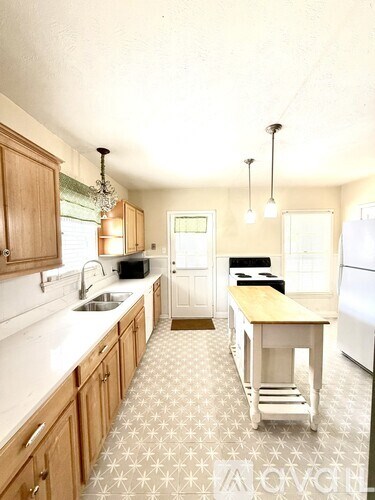 A kitchen with a table and chairs in the middle of the room.