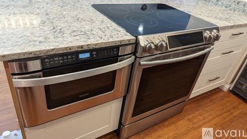 Two stainless steel ovens with digital displays and control panels are installed in a kitchen.
