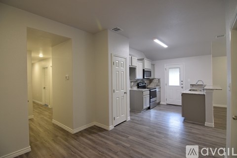 A kitchen area with a counter and cabinets.