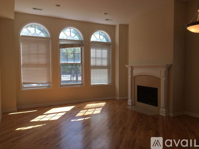 A living room with a fireplace and large windows.