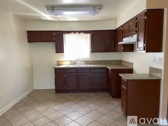 A kitchen with brown cabinets and a countertop.