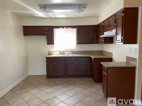 A kitchen with brown cabinets and a countertop.