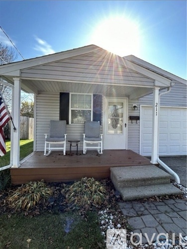 A house with a porch and a flag on the left side.