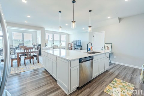A kitchen with a dishwasher and a fridge in it.