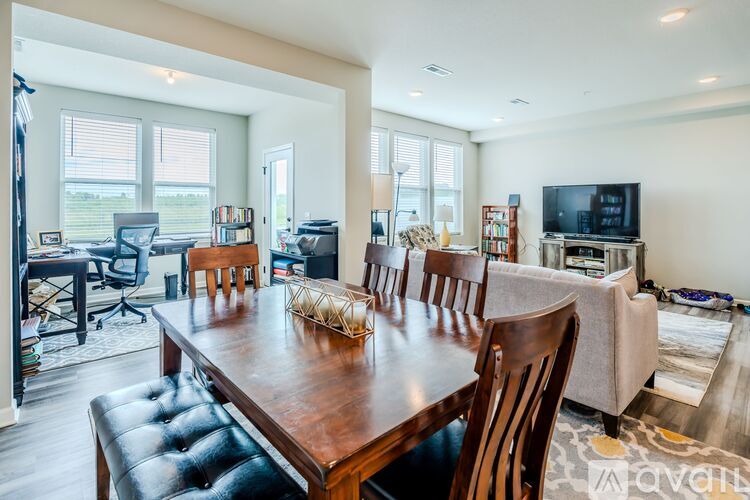 A dining room with a wooden table and chairs.