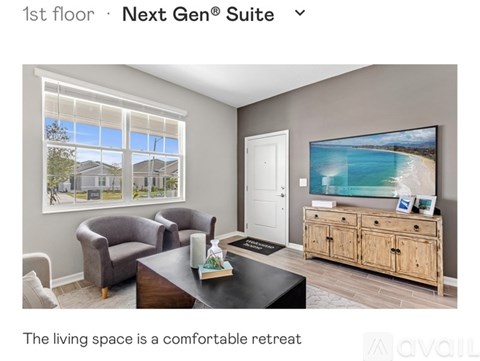 A living room with a couch, chair, and a television displaying a beach scene.