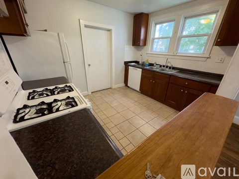 A kitchen with a stove top and a sink.