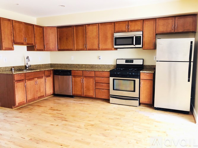 A kitchen with wooden cabinets and a white fridge.