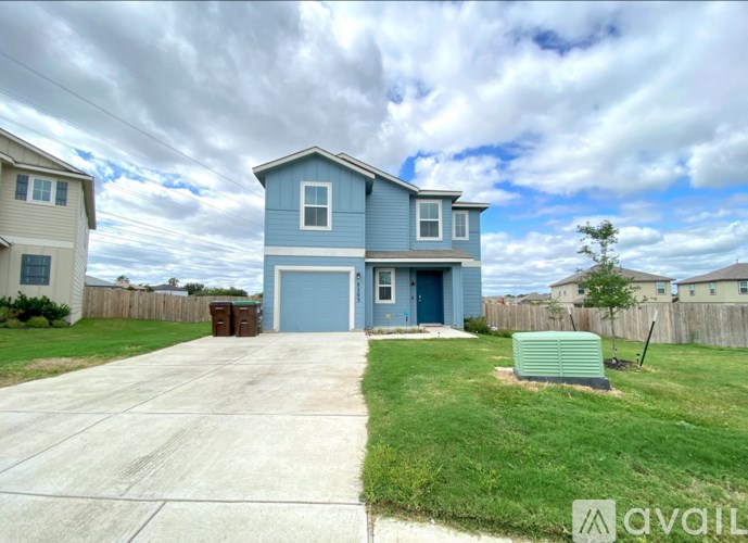 A blue house with a garage is for sale.