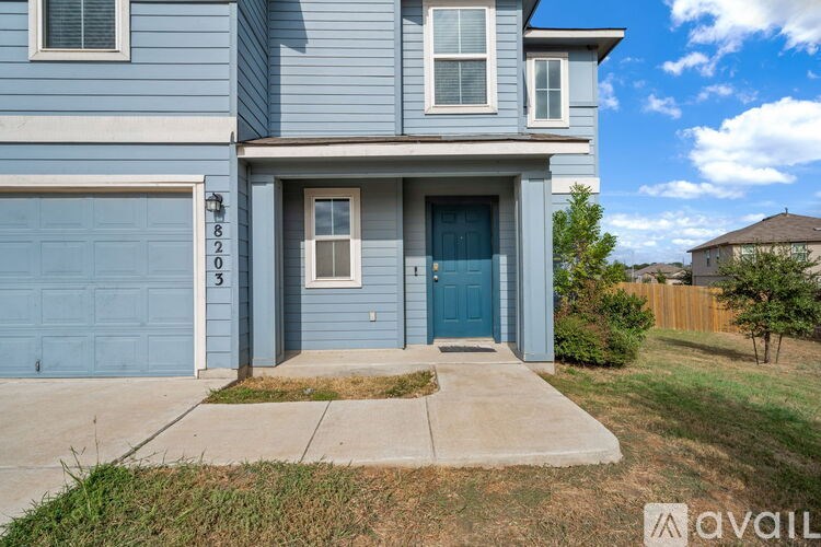 A hallway with a rug on the floor and a door on the right.