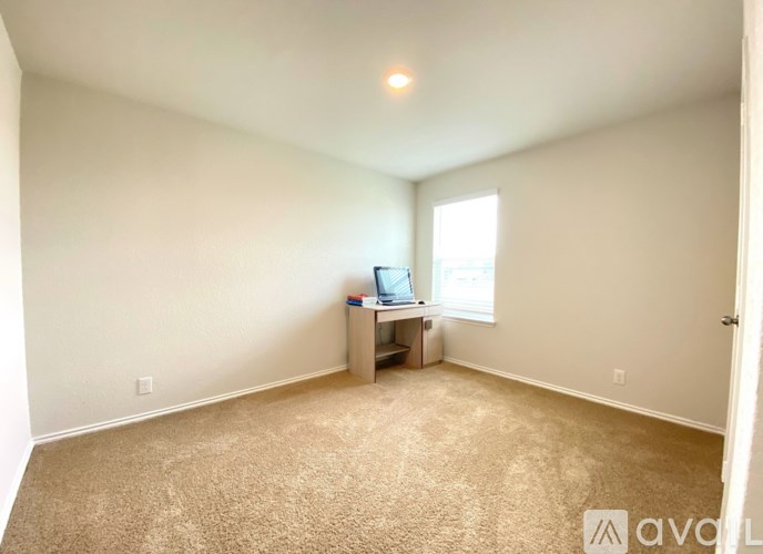 A room with a desk and a computer on it.