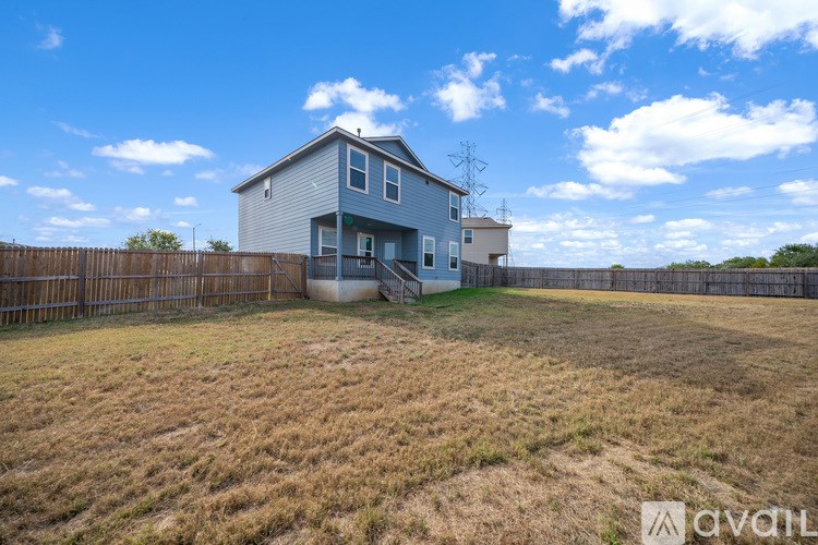 A house with a fence in front of it is for sale.