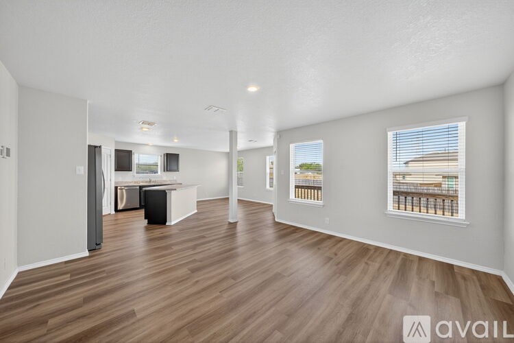 A living room with two brown leather sofas and a wooden floor.