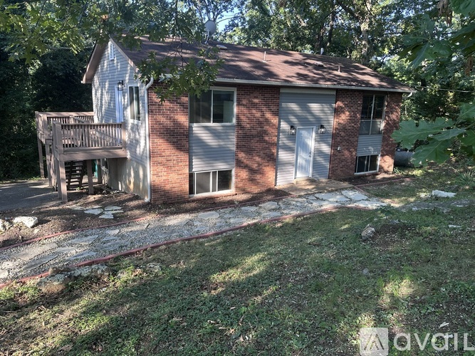 A house with a red brick exterior and a white garage door.