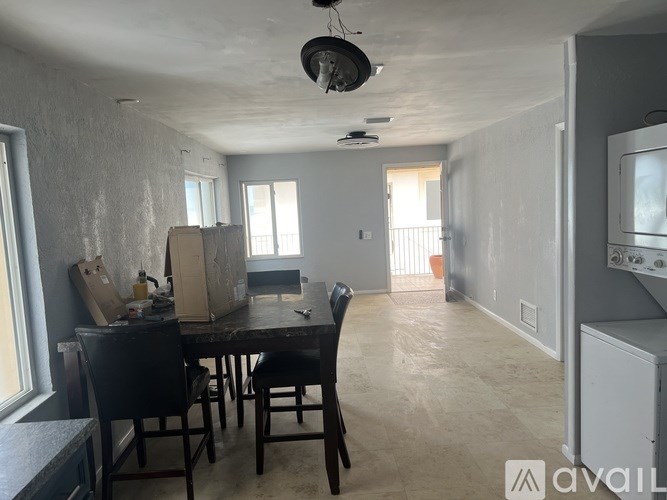 A room with a dining table and chairs is available for rent.