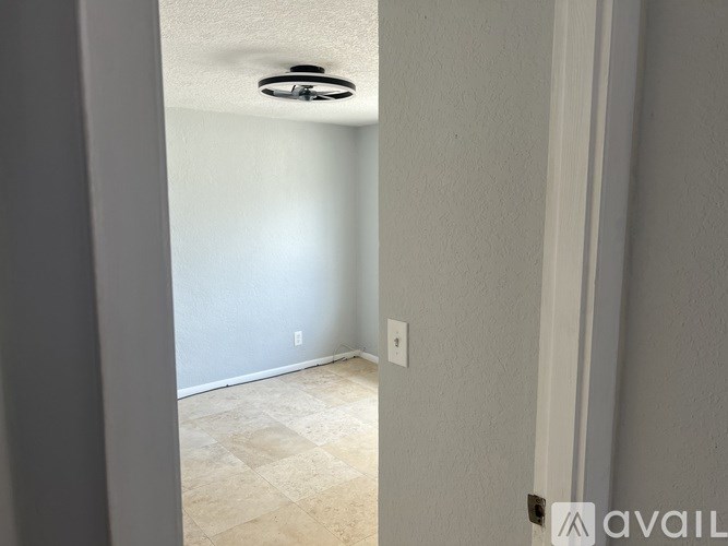 A room with a light fixture on the ceiling and a tiled floor.