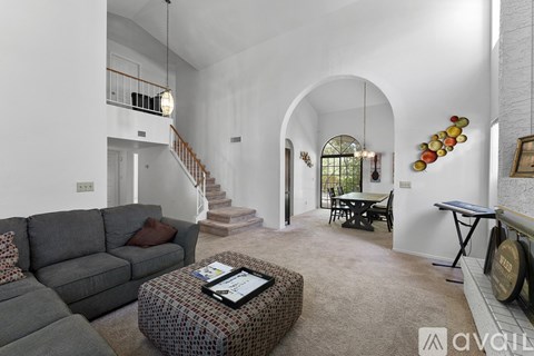 A living room with a grey couch and a coffee table.
