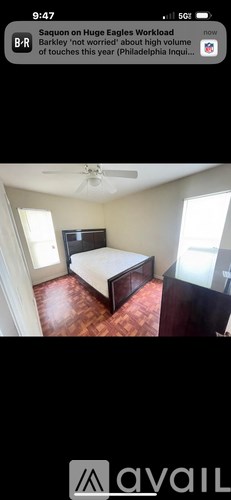 A bedroom with a bed, dresser, and ceiling fan.