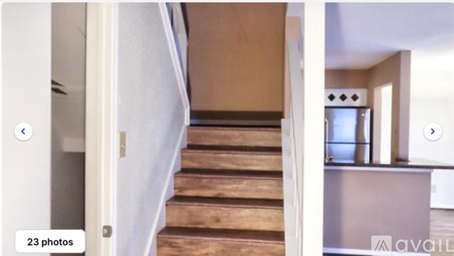 A staircase with wooden steps leading to a room with a television.