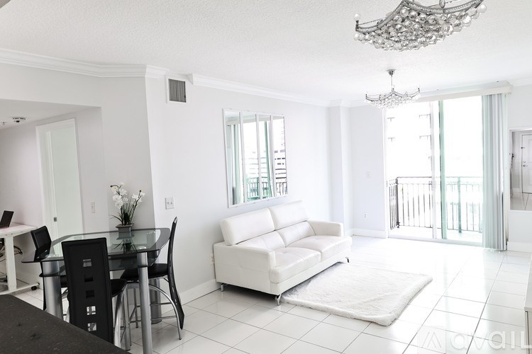 A dining room with a glass table and chairs.