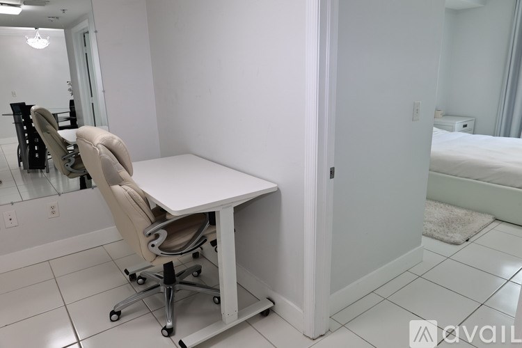 A white desk with a chair in a room.