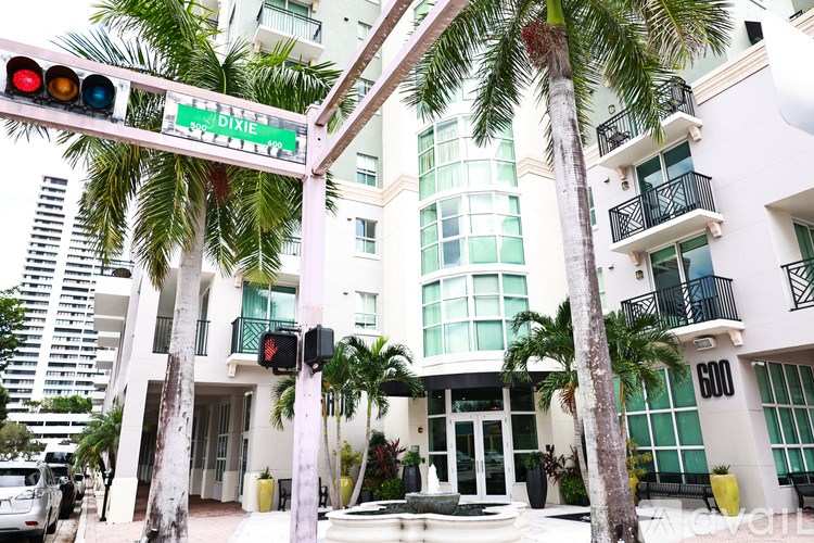 A traffic light with a green street sign above it that says Dixie.