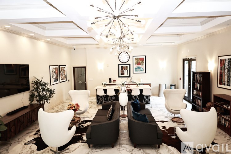 A living room with a white ceiling and a chandelier.