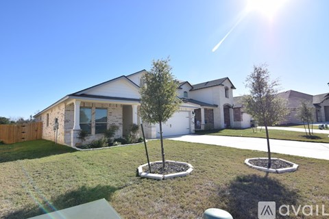 A house with a white fence and a green lawn.