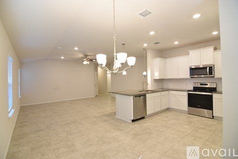 A kitchen with white cabinets and a microwave above the stove.