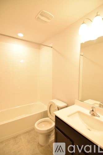 A bathroom with a toilet, sink, and bathtub.