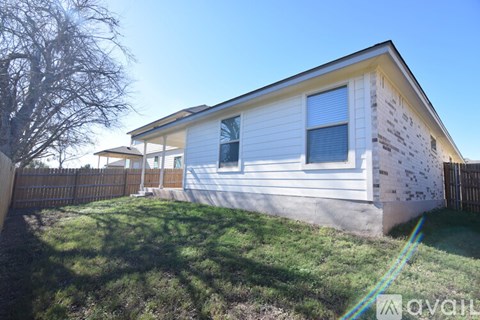 A house with a white siding and a yellow roof is shown.