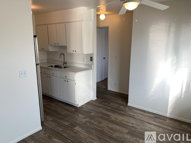 A kitchen with white cabinets and a sink.