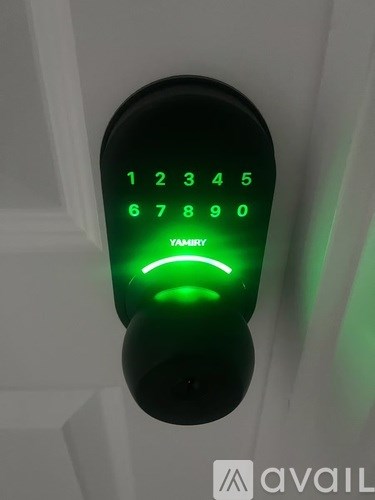 A keypad with numbers 1 to 9 and a green arrow is lit up.