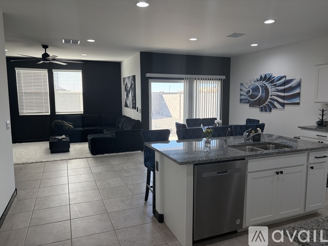 A modern kitchen with blue chairs and a dining table.