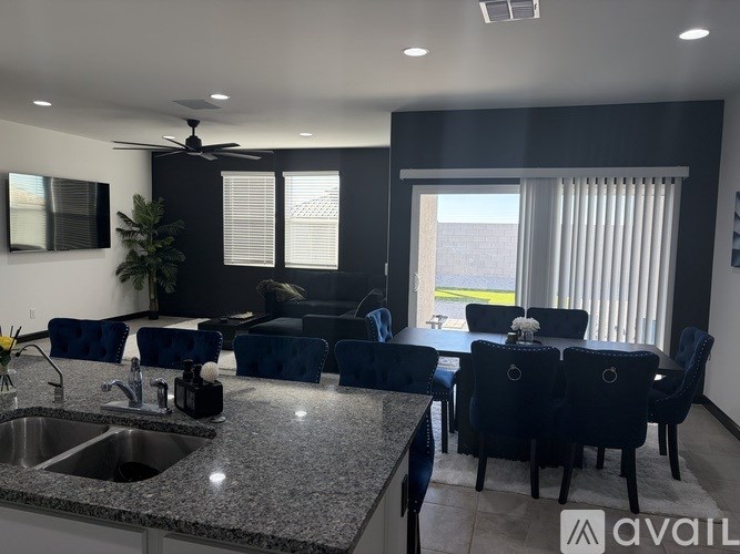 A kitchen with granite countertops and white cabinets.