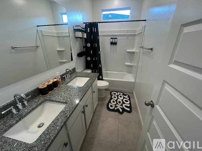 A bathroom with two sinks and a toilet.