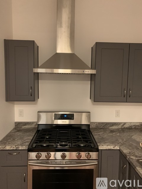 A kitchen with a stove and cabinets.