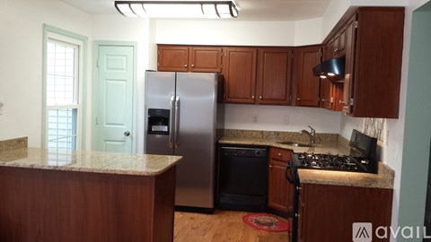 A kitchen with a refrigerator, stove, and dishwasher.
